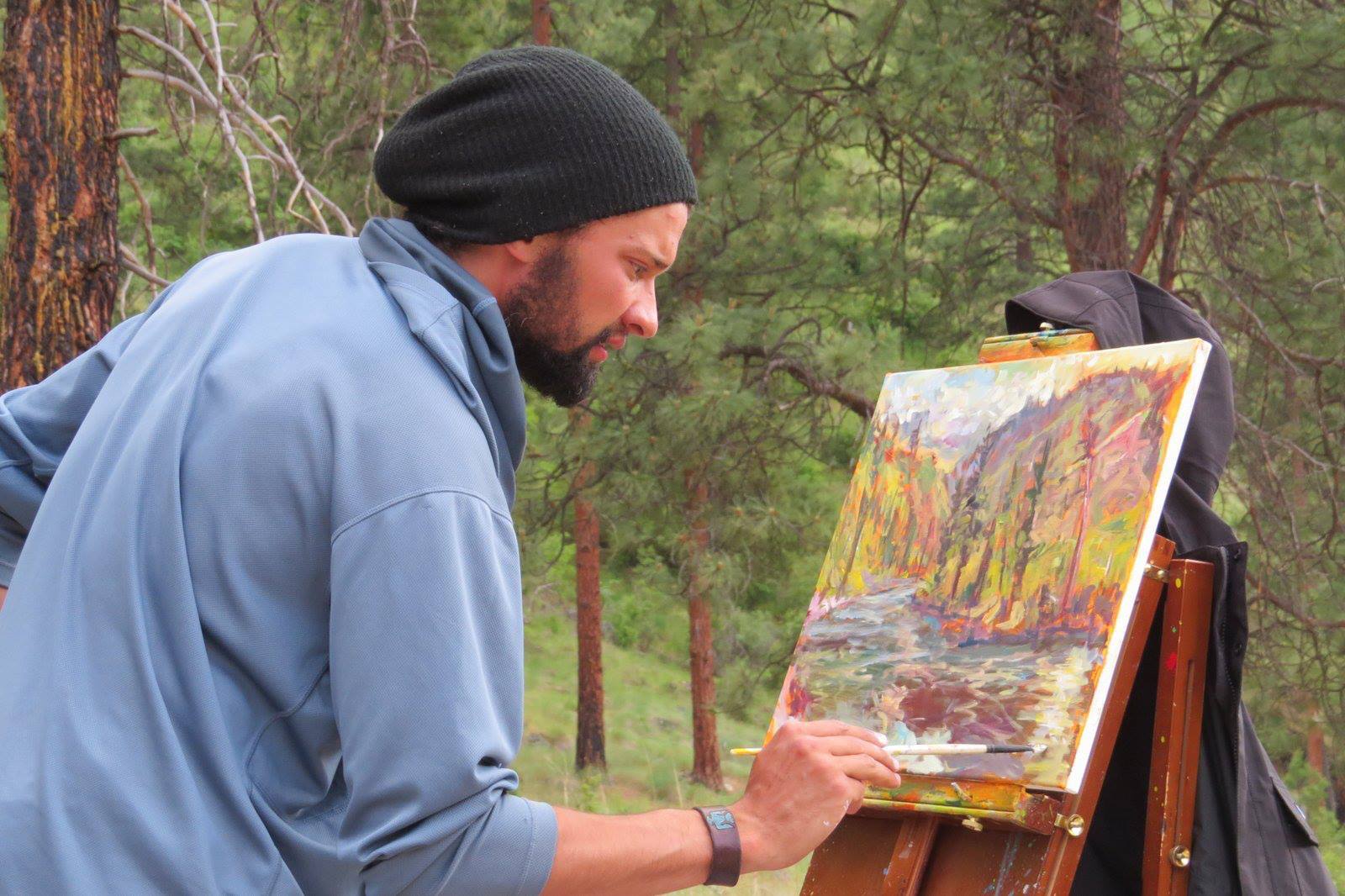 James paints along the river.